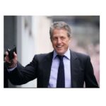 Hugh Grant settles claim against Sun publisher due to risk of £10m legal costs